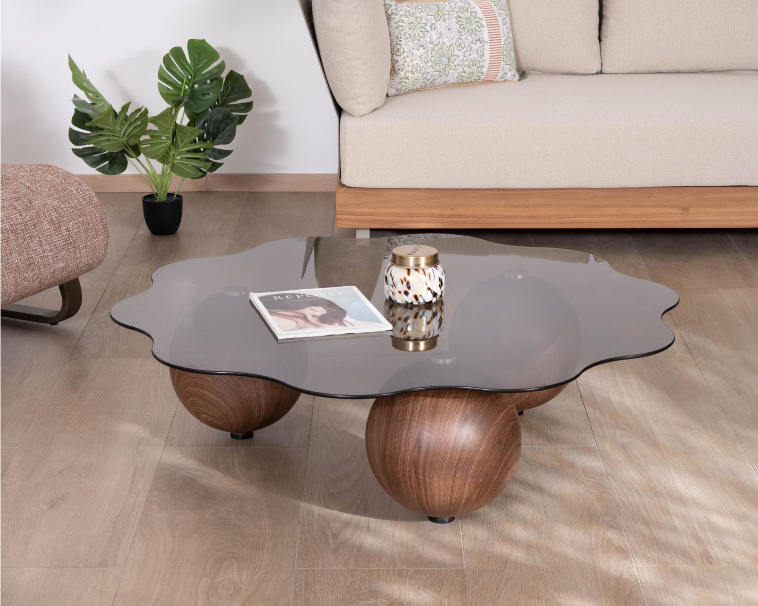 Table basse forme organique avec plateau en verre fumé "Cyléa" pieds boules